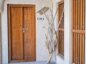 two wooden doors on the side of a building at Heritage Home Guest House in Dubai