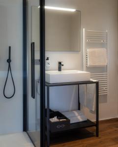 a bathroom with a sink and a mirror at The Foscarini in Mogliano Veneto