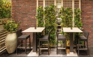 a patio with chairs and a table with plants at Dakota Glasgow in Glasgow