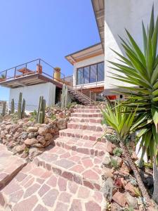 un conjunto de escaleras de piedra que conducen a una casa en Native Residence en Rosarito