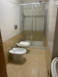 a bathroom with a shower and a toilet and a sink at casa GIRASOLE in Capannori