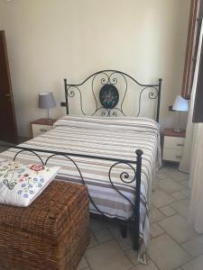 a bedroom with a bed with a black and white comforter at casa GIRASOLE in Capannori