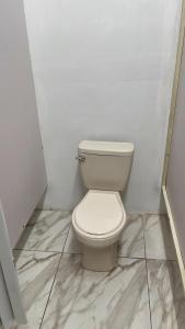 a bathroom with a white toilet in a stall at Rincon Dorms in Rincon