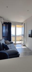 a living room with a couch and a large window at Kate's Studio with an amazing view in Dubrovnik