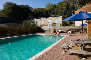 a swimming pool with people playing in the water at Porthallow in Budock Water