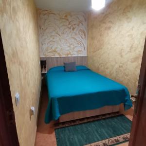a small room with a blue bed in it at Casa Rural El Rincon del descanso in Yebra +24 photos