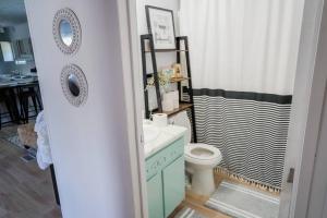 a bathroom with a sink and a toilet and a shower at Beautiful Stylish 3 bedroom home in Greenville in Greenville