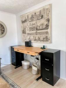 a desk in a room with a wall with drawings at Beautiful Stylish 3 bedroom home in Greenville in Greenville