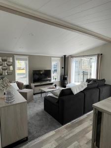 a living room with a couch and a tv at Holiday Lodge 6 in Porthcawl