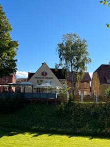 a house in a yard with a fence at Hostel Ingeri in Viljandi
