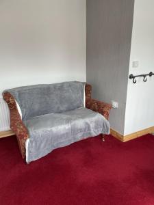 a couch sitting in the corner of a room at The Canteen Beautiful 1-Bed Apartment in Keswick in Threlkeld