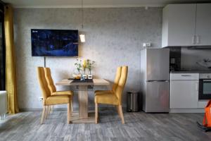 a kitchen with a table and chairs and a refrigerator at Manhattan 516 mit Schwimmbad in Braunlage
