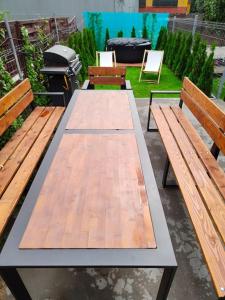 a picnic table with two benches and a grill at Apartament Japko in Gliwice +26 photos