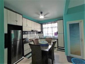 a kitchen with a table with a bowl on it at The Handz House II with WIFI - For family or same gender only in Kepala Batas