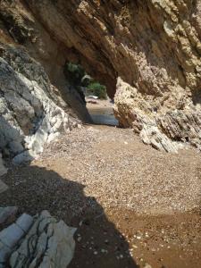 una cueva en una zona rocosa con un suelo de tierra en Bousounis Apartments, en Chrani