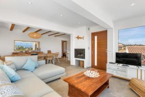 a living room with a couch and a table at Villa Reva - PlusHolidays in Calpe