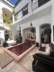 a living room with a pool in the middle at Riad El Jadide in Marrakesh
