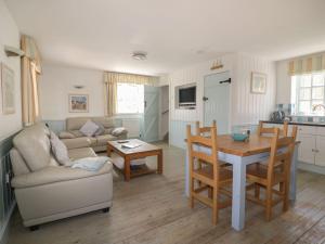 a living room with a couch and a table at Owls Roost in Saint Goran