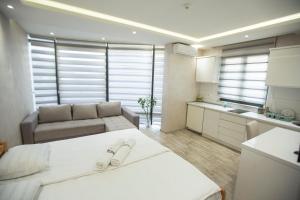 a kitchen and a living room with a bed and a couch at Apartmani Rekic-Dubai in Novi Pazar