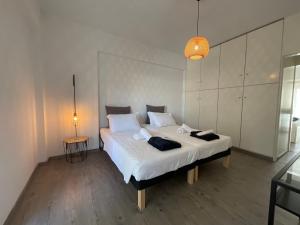 a bedroom with a large white bed with two pillows at MV central in Rhodes Town