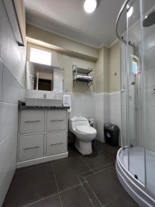 a bathroom with a toilet and a sink and a shower at Departamentos Caraz in Caraz