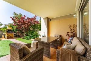 a patio with a table and chairs on a patio at Los Cristianos Duplex in Arona