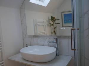a bathroom with a large white sink and a mirror at Cheltenham accommodation -self-catering-2 bedrooms in Cheltenham +22 photos