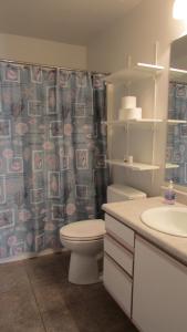 a bathroom with a toilet and a sink at Cozy home near freeways w pool BBQ in Peoria