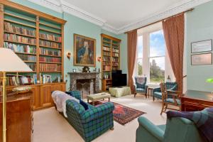 a living room filled with furniture and a fireplace at Dalnaglar Castle in Blairgowrie