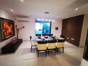 a dining room with a table and chairs at Spacious Home with Centric Location in Cancún