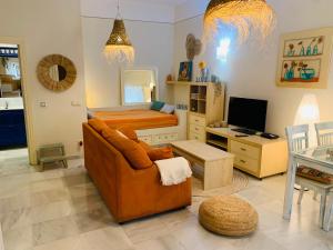 a living room with a couch and a bed at Lovely studio in Marbella close to Puente Romano in Marbella