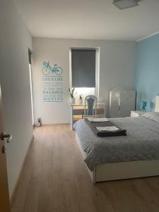 a bedroom with a bed and a bicycle sign on the wall at Apartman Botivo in Ludbreg