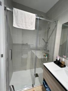 a bathroom with a shower and a toilet and a sink at Baiona Valley Hideaway Near Beach in Baiona