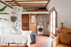 a living room with a bed and a refrigerator at Nice studio w balcony on Square Gardette in Paris - Welkeys in Paris