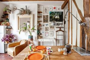 a living room with a table and a kitchen at Nice studio w balcony on Square Gardette in Paris - Welkeys in Paris