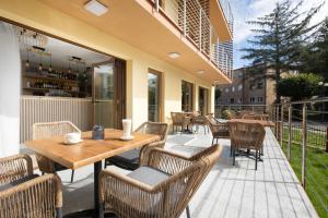 a patio with tables and chairs on a balcony at Willa Grand in Rewal