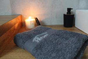 a candle and a blanket on a wooden table at Apartment Bajta - Rogla in Zreče