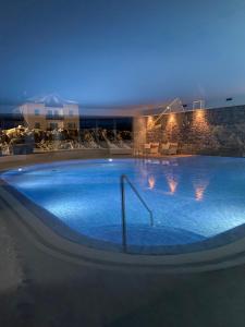 a large swimming pool in a hotel at night at Grand Hotel Miramonti in Passo del Tonale