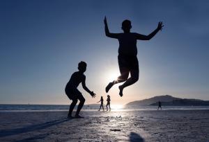 a group of people playing on the beach at Hotel Miramar Playa America Nigran in Nigrán