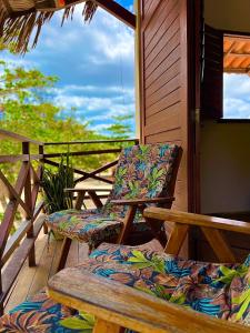 two chairs and a table on a porch at Residencial Bem-te-vi in Jericoacoara