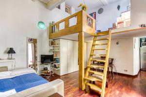 a bedroom with a bunk bed and a ladder at Maggiore 145 apartment with private garden - Rione Monti in Rome