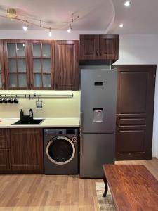 a kitchen with a washing machine and a sink at Dalv Residence - SPA Fairy Tale in old Sofia in Sofia