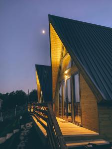 a house with a wooden porch on the side of it at La Baita - ლა ბაიტა 2 in Tbilisi City