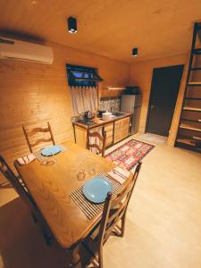 a dining room with a table and a kitchen at La Baita - ლა ბაიტა 2 in Tbilisi City