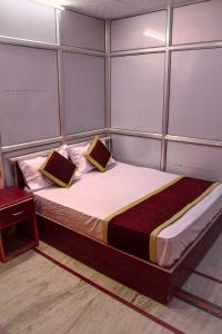 a bedroom with a bed with two pillows on it at Pink City Hostel in Jaipur