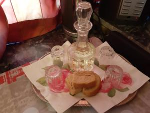 a plate with a sandwich and a bottle on a table at Jenny's house,Agiou Ioannou 103 in Artemida
