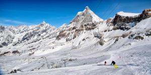 a group of people skiing down a snow covered mountain at Condominio Circus in Breuil-Cervinia