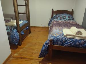 un dormitorio con una cama y una litera en Rossi, en Malargüe
