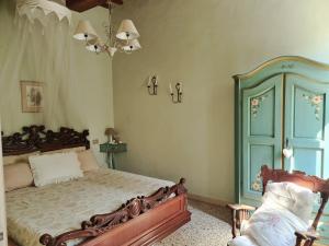 a bedroom with a bed and a blue cabinet at Le Rondini in Petrignano