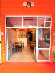 an open door of a restaurant with tables and chairs at Pink City Hostel in Jaipur
